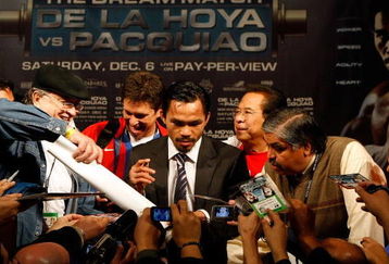 LAS VEGAS - DECEMBER 06:  Manny Pacquiao of the Philippines signs autographs at a news conference following his win over Oscar De La Hoya after their welterweight fight at the MGM Grand Garden Arena December 6, 2008 in Las Vegas, Nevada.  (Photo by Ethan Miller/Getty Images)