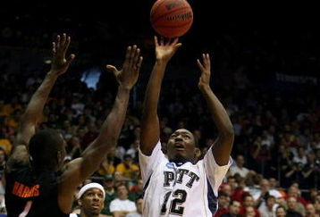 DAYTON, OH - MARCH 22: Ashton Gibbs #12 of the Pittsburgh Panthers shoots over Terrel Harris #1 of the Oklahoma State Cowboys during the second round of the NCAA Division I Men's Basketball Tournament at the University of Dayton Arena on March 22, 2009 in Dayton, Ohio.  (Photo by Andy Lyons/Getty Images)