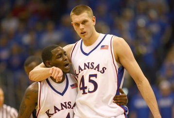 LAWRENCE, KANSAS - JANUARY 3:  Sherron Collins #4 and Cole Aldrich #45 of the Kansas Jayhawks walk on court against the Tennessee Volunteers on January 3, 2009 at Allen Fieldhouse in Lawrence, Kansas. (Photo by: Jamie Squire/Getty Images)