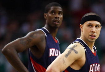 BOSTON - APRIL 30:  Mike Bibby #10 and Marvin Williams #24 of the Atlanta Hawks watch as Kevin Garnett of the Boston Celtics shoots a free throw during Game Five of the Eastern Conference Quarterfinals during the 2008 NBA Playoffs on April 30, 2008 at the TD Banknorth Garden in Boston, Massachusetts. The Celtics defeated the Hawks 110-85. NOTE TO USER: User expressly acknowledges and agrees that, by downloading and or using this Photograph, user is consenting to the terms and conditions of the Getty Images License Agreement.  (Photo by Elsa/Getty Images)