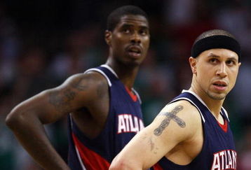 BOSTON - APRIL 30:  Mike Bibby #10 and Marvin Williams #24 of the Atlanta Hawks watch as Kevin Garnett of the Boston Celtics shoots a free throw during Game Five of the Eastern Conference Quarterfinals during the 2008 NBA Playoffs on April 30, 2008 at the TD Banknorth Garden in Boston, Massachusetts. The Celtics defeated the Hawks 110-85. NOTE TO USER: User expressly acknowledges and agrees that, by downloading and or using this Photograph, user is consenting to the terms and conditions of the Getty Images License Agreement.  (Photo by Elsa/Getty Images)