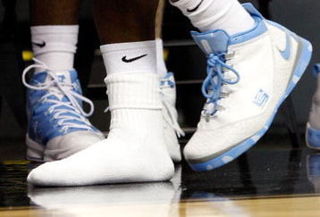 GREENSBORO, NC - MARCH 21:  Ty Lawson #5 of the North Carolina Tar Heels moves to the end of the bench for a checkup on his toe injury during the second round of the NCAA Division I Men's Basketball Tournament against the Louisiana State University Tigers at the Greensboro Coliseum on March 21, 2009 in Greensboro, North Carolina.  (Photo by Streeter Lecka/Getty Images)