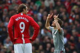 MANCHESTER, UNITED KINGDOM - MARCH 14:  Fabio Aurelio of Liverpool celebrates scoring his team's third goal as Dimitar Berbatov of Manchester United looks on during the Barclays Premier League match between Manchester United and Liverpool at Old Trafford on March 14, 2009 in Manchester, England.  (Photo by Laurence Griffiths/Getty Images)
