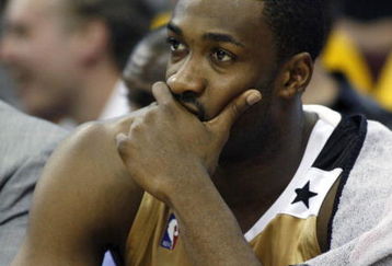 CLEVELAND - APRIL 21:  Gilbert Arenas #0 of the Washington Wizards looks on from the bench late in the game while playing the Cleveland Cavaliers in Game Two of the Eastern Conference Quarterfinals during the 2008 NBA Playoffs at Quicken Loans Arena April 21, 2008 in Cleveland, Ohio. Cleveland won the game 116-86. NOTE TO USER: User expressly acknowledges and agrees that, by downloading and or using this photograph, User is consenting to the terms and conditions of the Getty Images License Agreement.  (Photo by Gregory Shamus/Getty Images)