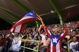 SAN JUAN, PUERTO RICO - MARCH 11:  Fans of Puerto Rico cheer against The Netherlands during the 2009 World Baseball Classic Pool D match on March 11, 2009 at Hiram Bithorn Stadium in San Juan, Puerto Rico.  (Photo by Al Bello/Getty Images)