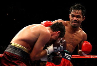 LAS VEGAS - DECEMBER 06:  (R-L) Manny Pacquiao of the Philippines connects with a right to the head of Oscar De La Hoya during their welterweight fight at the MGM Grand Garden Arena December 6, 2008 in Las Vegas, Nevada.  (Photo by Jed Jacobsohn/Getty Images)