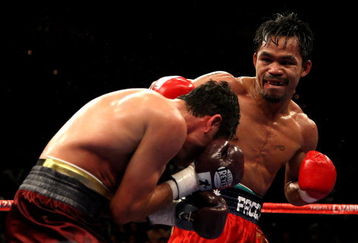 LAS VEGAS - DECEMBER 06:  (R-L) Manny Pacquiao of the Philippines connects with a right to the head of Oscar De La Hoya during their welterweight fight at the MGM Grand Garden Arena December 6, 2008 in Las Vegas, Nevada.  (Photo by Jed Jacobsohn/Getty Images)