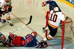 11 Jun 1994: PAVEL BURE HANGS ON THE CROSS BAR TO AVOID DIVING RANGERS GOALTENDER MIKE RICHTER DURING THE FIRST PERIOD OF GAME SIX OF THE STANLEY CUP FINALS IN VANCOUVER, BRITISH COLUMBIA.