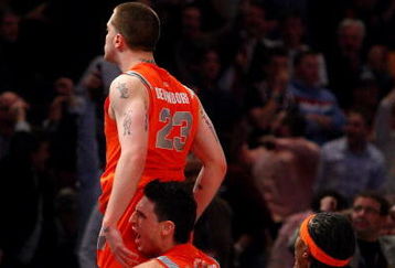 NEW YORK - MARCH 12: Eric Devendorf #23, Andy Rautins #1 and Paul Harris #11 of the Syracuse Orange celebrate after Devendorf made a game-winning basket that was ruled no good due to time running out against the Connecticut Huskies during the quarterfinals of the Big East Tournament at Madison Square Garden on March 12, 2009 in New York City.  (Photo by Jim McIsaac/Getty Images)