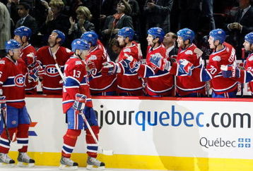 MONTREAL- MARCH 10:  Andrei Kostitsyn #46 and Alex Tanguay #13 of the Montreal Canadiens celebrate the third period goal by Saku Koivu #11 with teammates during the game against the Edmonton Oilers at the Bell Centre on March 10, 2009 in Montreal, Quebec, Canada.  The Canadiens defeated the Oilers 4-3 in overtime.  (Photo by Richard Wolowicz/Getty Images)
