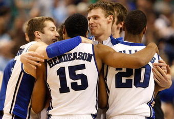 GREENSBORO, NC - MARCH 21:  Greg Paulus #3 and Martynas Pocius #5 of the Duke Blue Devils congratulate Gerald Henderson #15 and Elliot Williams #20 after their 74-69 win over the Texas Longhorns during the second round of the NCAA Division I Men's Basketball Tournament at the Greensboro Coliseum on March 21, 2009 in Greensboro, North Carolina.  (Photo by Streeter Lecka/Getty Images)