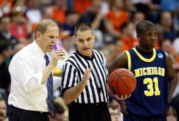 KANSAS CITY, MO - MARCH 19:  NCAA Referee Kelly Self speaks to Head Coach John Beilein of the Michigan Wolverines during the first round of the NCAA Division I Men's Basketball Tournament between the Michigan Wolverines and the Clemson Tigers at the Sprint Center on March 19, 2009 in Kansas City, Missouri. The Wolverines defeated the Tigers 62-59. (Photo by Jamie Squire/Getty Images)