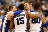 GREENSBORO, NC - MARCH 21:  Greg Paulus #3 and Martynas Pocius #5 of the Duke Blue Devils congratulate Gerald Henderson #15 and Elliot Williams #20 after their 74-69 win over the Texas Longhorns during the second round of the NCAA Division I Men's Basketball Tournament at the Greensboro Coliseum on March 21, 2009 in Greensboro, North Carolina.  (Photo by Streeter Lecka/Getty Images)