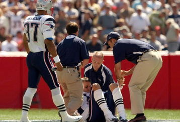 FOXBORO, MA - SEPTEMBER 7:  Quarterback Tom Brady #12 of the New England Patriots stands up with the aid of the Patriots staff after being injured on a play during their NFL game against the Kansas City Chiefs on September 7, 2008 at Gillette Stadium in Foxboro, Massachusetts. The Patriots defeated the Chiefs 17-10. (Photo by Elsa Garrison/Getty Images)