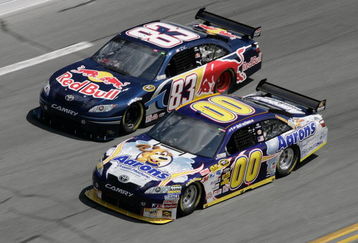 DAYTONA BEACH, FL - FEBRUARY 11:  David Reutimann driver of the #00 Aaron's Dream Machine Toyota races with Brian Vickers driver of the #83 Red Bull Toyota during practice for the NASCAR Sprint Cup Series Daytona 500 at Daytona International Speedway on February 11, 2009 in Daytona Beach, Florida.  (Photo by John Harrelson/Getty Images for NASCAR)