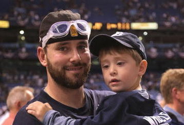 ST PETERSBURG, FL - OCTOBER 19:  Dan Wheeler #35 celebrates with his son after defeating the Boston Red Sox in game seven of the American League Championship Series during the 2008 MLB playoffs on October 19, 2008 at Tropicana Field in St Petersburg, Florida.  The Rays defeated the Red Sox 3-1 to win the series 4-3.  (Photo by Doug Pensinger/Getty Images)