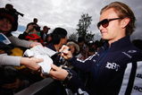 MELBOURNE, AUSTRALIA - MARCH 27:  Nico Rosberg of Germany and Williams signs autographs for race fans prior to practice for the Australian Formula One Grand Prix at the Albert Park Circuit on March 27, 2009 in Melbourne, Australia.  (Photo by Mark Thompson/Getty Images)