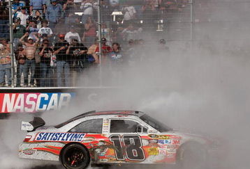 BRISTOL, TN - MARCH 22:  Kyle Busch, driver of the #18 Snickers Toyota, does a burnout after winning the NASCAR Sprint Cup Series Food City 500 at Bristol Motor Speedway on March 22, 2009 in Bristol, Tennessee.  (Photo by Jerry Markland/Getty Images for NASCAR)