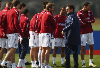 ST ALBANS, ENGLAND - MARCH 24:  England manager Fabio Capello talks with David Beckham during England training at London Colney on March 24, 2009 in St Albans, England.  (Photo by Jamie McDonald/Getty Images)