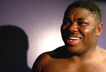 LOS ANGELES, CA - SEPTEMBER 2: Samuel Peter smiles in his locker room after he is declared the winner by split decision after his WBC heavyweight title elimination/NABF & IBA heavyweight championship fight against James Toney at Staples Center on September 2, 2006 in Los Angeles, California. (Photo by Donald Miralle/Getty Images)