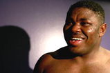 LOS ANGELES, CA - SEPTEMBER 2: Samuel Peter smiles in his locker room after he is declared the winner by split decision after his WBC heavyweight title elimination/NABF & IBA heavyweight championship fight against James Toney at Staples Center on September 2, 2006 in Los Angeles, California. (Photo by Donald Miralle/Getty Images)