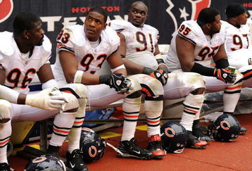 HOUSTON - DECEMBER 28:  Tommie Harris #91 and Adewale Ogunleye #93 of the Chicago Bears watch play from the bench in the final minutes of a 31-24 loss to the Houston Texans at the Reliant Stadium December 28, 2008 in Houston, Texas.  The Bears failed to make the playoffs.  (Photo by Harry How/Getty Images)