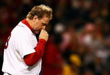 BOSTON - OCTOBER 20:  Starting pitcher Curt Schilling #38 of the Boston Red Sox kisses his necklace as he says a prayer before taking on the Cleveland Indians in Game Six of the American League Championship Series at Fenway Park on October 20, 2007 in Boston, Massachusetts.  (Photo by Al Bello/Getty Images)