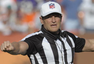 MIAMI, FL - JANUARY 4:  NFL referee Ed Hochuli directs play as the Miami Dolphins host the Baltimore Ravens in an NFL Wildcard Playoff Game at Dolphins Stadium on January 4, 2009 in Miami, Florida.  (Photo by Al Messerschmidt/Getty Images) 
