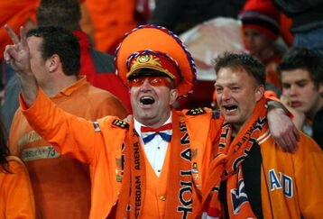 AMSTERDAM, NETHERLANDS - MARCH 28:  The fans of Netherlands celebrate during the FIFA 2010 World Cup qualifying match between Netherlands and Scotland at the Arena on March 28, 2009 in Amsterdam, Netherlands.  (Photo by Christof Koepsel/Getty Images)