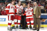 BOSTON - FEBRUARY 14:  Boston University captains David Van der Gulik #7, Brian McConnell #9 and Brad Zancanaro #12 accept the Beanpot Trophy with their coach Jack Parker at the 2005 Beanpot Tournament on February 14, 2005 in Boston, Massachusetts.  (Photo by Brian Babineau/Getty Images)