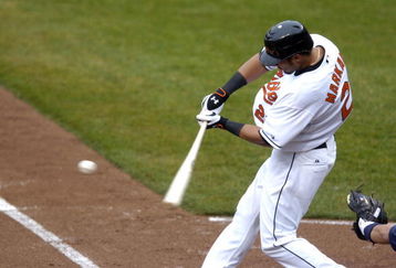 BALTIMORE - MARCH 31:  Nick Markakis #21 of the Baltimore Orioles hits a single against the Tampa Bay Rays on Opening Day March 31, 2008 at Camden Yards in Baltimore, Maryland.  (Photo by Greg Fiume/Getty Images)
