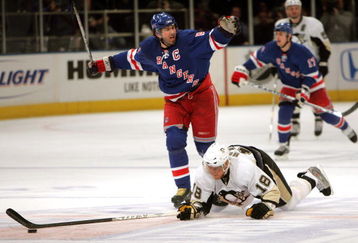 NEW YORK - APRIL 29:  Jaromir Jagr #68 of the New York Rangers hooks Marian Hossa #18 of the Pittsburgh Penguins who dives for the puck during Game 3 of the Eastern Conference Semifinals of the 2008 NHL Stanley Cup Playoffs at Madison Square Garden on April 29th, 2008 in New York City.  Jagr recieved a two minute penalty for hooking while Hossa recieved a two minute penalty for unsportsmanlike diving.  (Photo by Bruce Bennett/Getty Images)