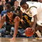 INDIANAPOLIS - MARCH 12: Manny Harris #3 of the Michigan Wolveriens attempts to control a loose ball against Jarryd Cole #50 of the Iowa Hawkeyes during the first round of the Big Ten Men's Basketball Tournament at Conseco Fieldhouse on March 12, 2009 in Indianapolis, Indiana. (Photo by Jonathan Daniel/Getty Images)