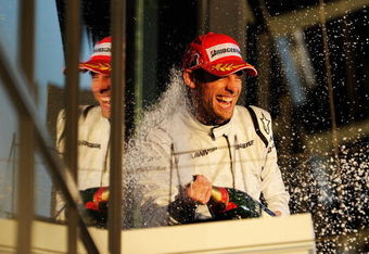 MELBOURNE, AUSTRALIA - MARCH 29:  Jenson Button of Great Britain and Brawn GP celebrates on the podium as he wins the Australian Formula One Grand Prix at the Albert Park Circuit on March 29, 2009 in Melbourne, Australia.  (Photo by Robert Cianflone/Getty Images)