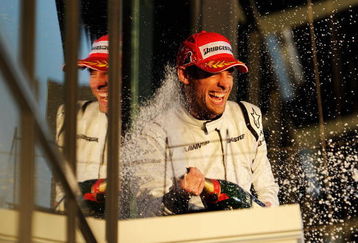 MELBOURNE, AUSTRALIA - MARCH 29:  Jenson Button of Great Britain and Brawn GP celebrates on the podium as he wins the Australian Formula One Grand Prix at the Albert Park Circuit on March 29, 2009 in Melbourne, Australia.  (Photo by Robert Cianflone/Getty Images)