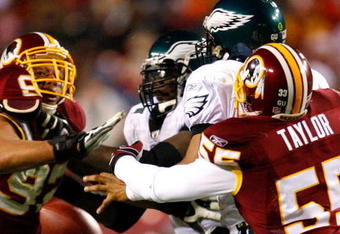LANDOVER, MD - DECEMBER 21:  Jason Taylor #55 of the Washington Redskins forces a fumble as he knocks the ball out of the hands of quarterback Donovan McNabb #5 of the Philadelphia Eagles during the game on December 21, 2008 at FedEx Field in Landover, Maryland.  (Photo by Kevin C. Cox/Getty Images)