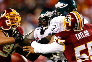 LANDOVER, MD - DECEMBER 21:  Jason Taylor #55 of the Washington Redskins forces a fumble as he knocks the ball out of the hands of quarterback Donovan McNabb #5 of the Philadelphia Eagles during the game on December 21, 2008 at FedEx Field in Landover, Maryland.  (Photo by Kevin C. Cox/Getty Images)