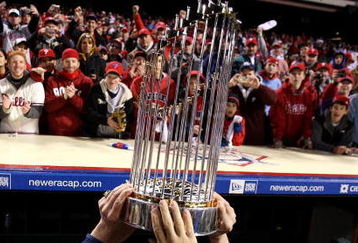 PHILADELPHIA - OCTOBER 29:  The World Series Championship trophy is held up in front of fans of the Philadelphia Phillies after they won 4-3 against the Tampa Bay Rays during the continuation of game five of the 2008 MLB World Series on October 29, 2008 at Citizens Bank Park in Philadelphia, Pennsylvania.  (Photo by Jed Jacobsohn/Getty Images)