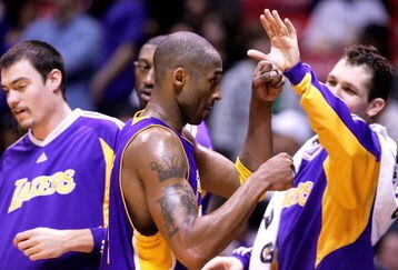EAST RUTHERFORD, NJ - MARCH 27:  Kobe Bryant #24 of the Los Angeles Lakers celebrates with team mates fatre defeating the New Jersey Nets during their game on March 27, 2009 at the Izod Center in East Rutherford, New Jersey. NOTE TO USER: User expressly acknowledges and agrees that, by downloading and/or using this Photograph, User is consenting to the terms and conditions of the Getty Images License Agreement.  (Photo by Chris McGrath/Getty Images)