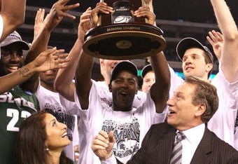 INDIANAPOLIS - MARCH 29:  Head coach Tom Izzo of the Michigan State Spartans and his wife, Lupe, celebrate with the Michigan State players after they were presented with the midwest region trophy following their 64-52 win against the Louisville Cardinals during the fourth round of the NCAA Division I Men's Basketball Tournament at the Lucas Oil Stadium on March 29, 2009 in Indianapolis, Indiana.  (Photo by Andy Lyons/Getty Images)