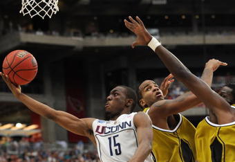 GLENDALE, AZ - MARCH 28:  (L-R) Guard Kemba Walker #15 of the Connecticut Huskies goes up for a shot against forwards Leo Lyons #5 and DeMarre Carroll #1 of the Missouri Tigers in the Elite Eight of the NCAA Division I Men's Basketball Tournament at the University of Phoenix Stadium on March 28, 2009 in Glendale, Arizona.  (Photo by Ronald Martinez/Getty Images)