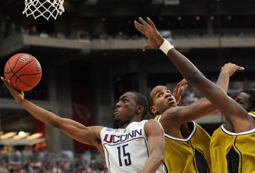 GLENDALE, AZ - MARCH 28:  (L-R) Guard Kemba Walker #15 of the Connecticut Huskies goes up for a shot against forwards Leo Lyons #5 and DeMarre Carroll #1 of the Missouri Tigers in the Elite Eight of the NCAA Division I Men's Basketball Tournament at the University of Phoenix Stadium on March 28, 2009 in Glendale, Arizona.  (Photo by Ronald Martinez/Getty Images)