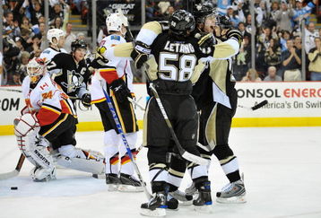 PITTSBURGH - MARCH 25: Kris Letang #58, Evgeni Malkin #71 and Chris Kunitz #14 of the Pittsburgh Penguins celebrate Letang's first period power play goal against the Calgary Flames on March 25, 2009 at Mellon Arena in Pittsburgh, Pennsylvania.  (Photo by Jamie Sabau/Getty Images)
