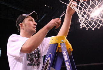 INDIANAPOLIS - MARCH 29:  Goran Suton #14 of the Michigan State Spartans cuts down a piece of the net following their 64-52 win against the Louisville Cardinals  during the fourth round of the NCAA Division I Men's Basketball Tournament at the Lucas Oil Stadium on March 29, 2009 in Indianapolis, Indiana.  (Photo by Chris Chambers/Getty Images)