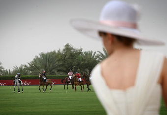 DUBAI, UNITED ARAB EMIRATES - MARCH 27:  A lady in a hat watches the action during the Cartier International Dubai Polo Challenge at the Desert Palm Hotel on March 27, 2009 in Dubai, United Arab Emirates. The event takes place under the patronage of HRH Princess Haya Bint Al Hussein, wife of HH Sheikh Mohammed Bin Rashid Al Maktoum, Vice President and Prime Minister of UAE Ruler of Dubai. The Cartier International Dubai Polo Challenge is the most celebrated tournament in the desert and one of three Cartier hosts each year including the Royal Cartier International Windsor Polo and Saint-Moritz Snow Polo event.  (Photo by Chris Jackson/Getty Images for Cartier)