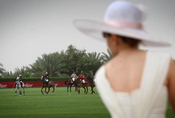 DUBAI, UNITED ARAB EMIRATES - MARCH 27:  A lady in a hat watches the action during the Cartier International Dubai Polo Challenge at the Desert Palm Hotel on March 27, 2009 in Dubai, United Arab Emirates. The event takes place under the patronage of HRH Princess Haya Bint Al Hussein, wife of HH Sheikh Mohammed Bin Rashid Al Maktoum, Vice President and Prime Minister of UAE Ruler of Dubai. The Cartier International Dubai Polo Challenge is the most celebrated tournament in the desert and one of three Cartier hosts each year including the Royal Cartier International Windsor Polo and Saint-Moritz Snow Polo event.  (Photo by Chris Jackson/Getty Images for Cartier)