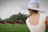 DUBAI, UNITED ARAB EMIRATES - MARCH 27:  A lady in a hat watches the action during the Cartier International Dubai Polo Challenge at the Desert Palm Hotel on March 27, 2009 in Dubai, United Arab Emirates. The event takes place under the patronage of HRH Princess Haya Bint Al Hussein, wife of HH Sheikh Mohammed Bin Rashid Al Maktoum, Vice President and Prime Minister of UAE Ruler of Dubai. The Cartier International Dubai Polo Challenge is the most celebrated tournament in the desert and one of three Cartier hosts each year including the Royal Cartier International Windsor Polo and Saint-Moritz Snow Polo event.  (Photo by Chris Jackson/Getty Images for Cartier)