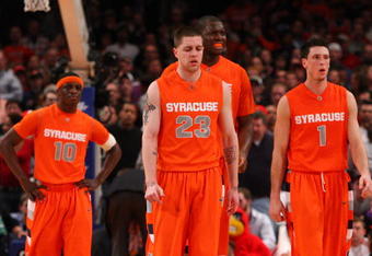 NEW YORK - MARCH 14:  Eric Devendorf #23, Andy Rautins #1, Rick Jackson #00 and Jonny Flynn #10 of the Syracuse Orange walk off of the court after a time out while playing against the Louisville Cardinals during the championship game of the Big East Tournament at Madison Square Garden on March 14, 2009 in New York City.  (Photo by Jim McIsaac/Getty Images)