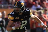 TAMPA, FL - JANUARY 01:  Ricky Stanzi #12 of the Iowa Hawkeyes runs upfield against the South Carolina Gamecocks during the Outback Bowl on January 1, 2009 at Raymond James Stadium in Tampa, Florida.  (Photo by Scott Halleran/Getty Images)