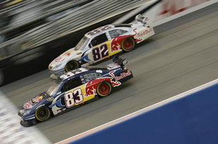 FONTANA, CA - FEBRUARY 22: Brian Vickers, driver of the #83 Red Bull Toyota, races teammate Scott Speed, driver of the #82 Red Bull Toyota, during the NASCAR Sprint Cup Series Auto Club 500 at Auto Club Speedway on February 22, 2009 in Fontana, California.  (Photo by Geoff Burke/Getty Images for NASCAR)